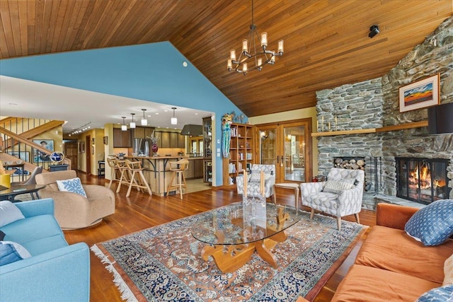 83 Dewey Farm Rd, Stowe, VT 05672 - living area featuring stairs, wood finished floors, a chandelier, a fireplace, and wooden ceiling