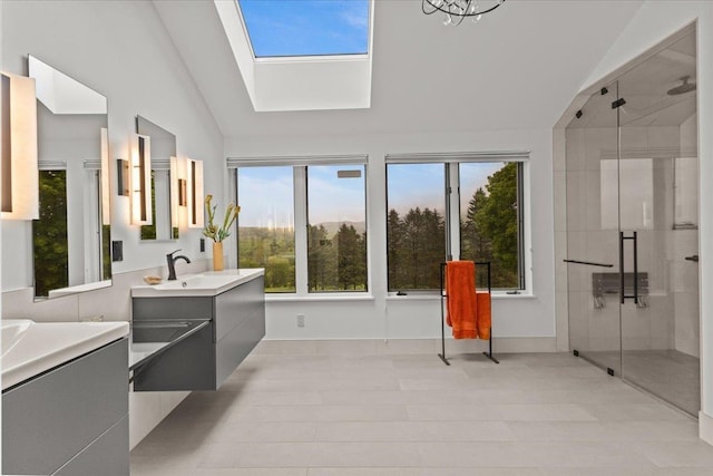 83 Dewey Farm Rd, Stowe, VT 05672 - bathroom featuring high vaulted ceiling, two vanities, a stall shower, plenty of natural light, and a skylight