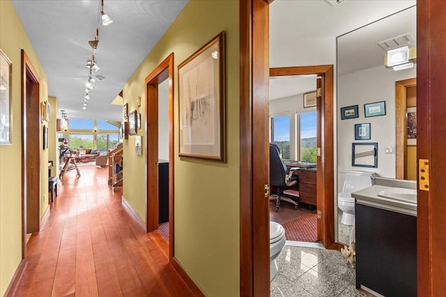 83 Dewey Farm Rd, Stowe, VT 05672 - corridor with track lighting, an office area, and baseboards