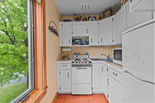 83 Dewey Farm Rd, Stowe, VT 05672 - kitchen featuring white appliances, a sink, light countertops, light tile patterned floors, and white cabinets