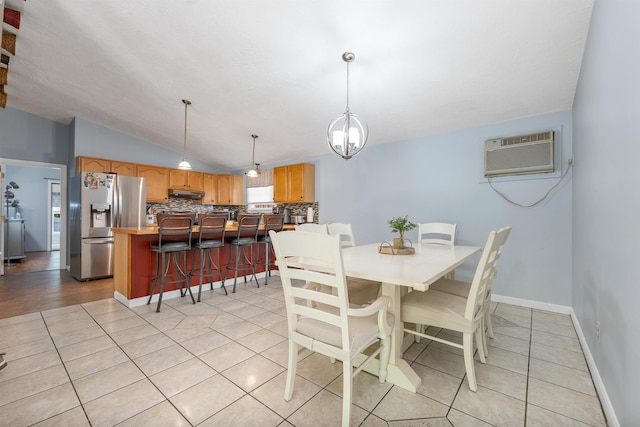 4 Johns Dr Unit A, Hooksett, NH 03106 - dining room featuring a wall mounted AC, vaulted ceiling, light tile patterned flooring, baseboards, and a chandelier