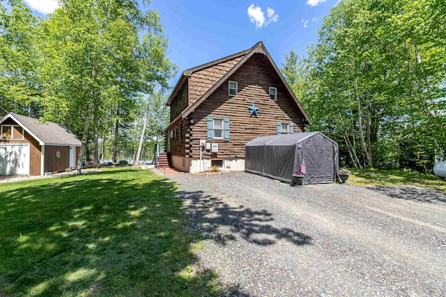 72 Auclair Rd, Middleton, NH 03887 - view of side of property featuring log siding, a yard, and driveway