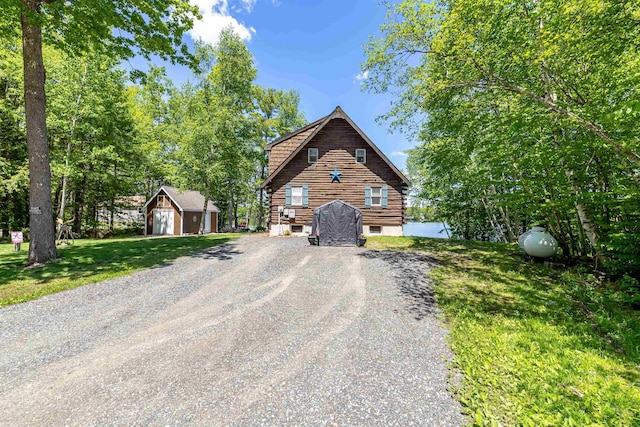 72 Auclair Rd, Middleton, NH 03887 - view of front of house featuring an outbuilding, driveway, log siding, and a front lawn