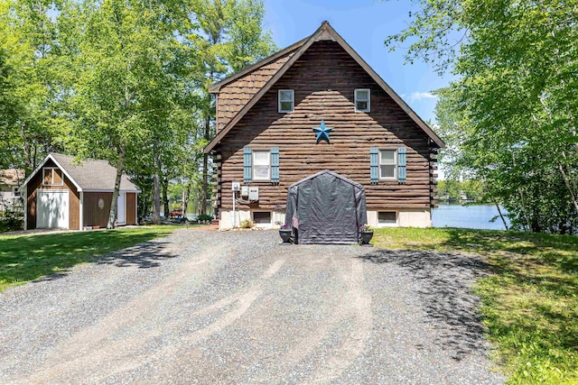 72 Auclair Rd, Middleton, NH 03887 - view of front of home with log exterior, an outdoor structure, and driveway