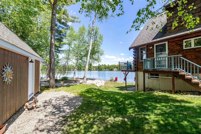 72 Auclair Rd, Middleton, NH 03887 - view of grassy yard featuring a deck with water view