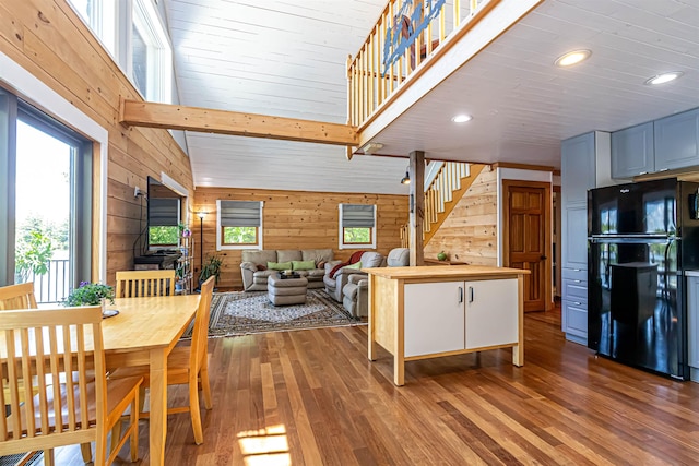 72 Auclair Rd, Middleton, NH 03887 - dining area featuring hardwood / wood-style floors, stairs, wood walls, recessed lighting, and a high ceiling