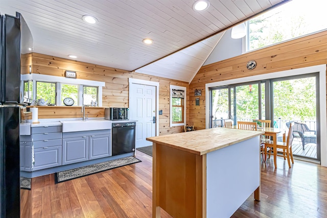 72 Auclair Rd, Middleton, NH 03887 - kitchen with black appliances, butcher block countertops, a sink, wood-type flooring, and wood walls