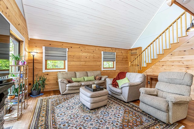 72 Auclair Rd, Middleton, NH 03887 - living area with wood walls, wood-type flooring, stairs, and high vaulted ceiling