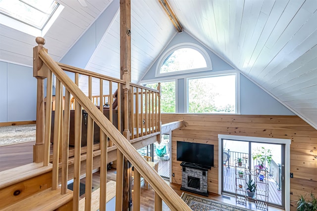 72 Auclair Rd, Middleton, NH 03887 - living area featuring a skylight, wood walls, and a stone fireplace