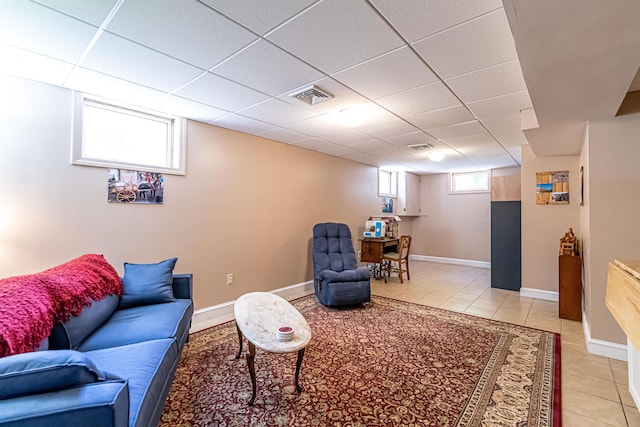 72 Auclair Rd, Middleton, NH 03887 - living area featuring light tile patterned floors, a drop ceiling, and baseboards