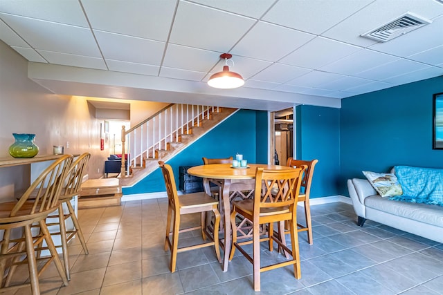 72 Auclair Rd, Middleton, NH 03887 - tiled dining area featuring stairway, a drop ceiling, and baseboards