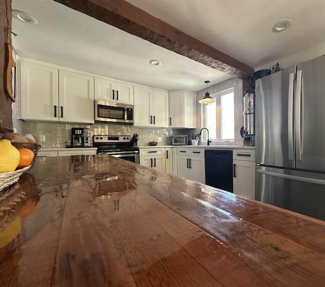 8 Main St, Bennington, NH 03442 - kitchen featuring appliances with stainless steel finishes, decorative backsplash, white cabinetry, dark stone countertops, and recessed lighting