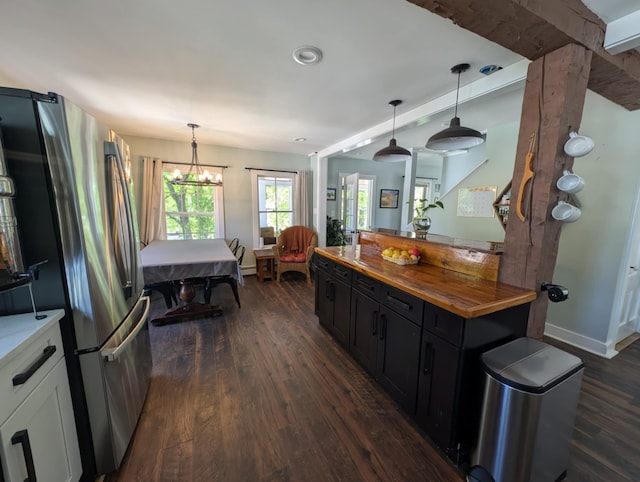 8 Main St, Bennington, NH 03442 - kitchen with wooden counters, dark cabinets, dark wood-style flooring, and freestanding refrigerator