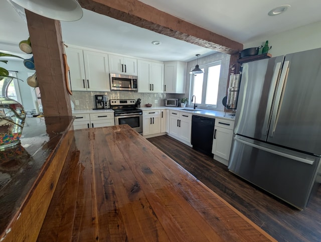 8 Main St, Bennington, NH 03442 - kitchen featuring appliances with stainless steel finishes, a sink, dark wood finished floors, decorative backsplash, and white cabinets
