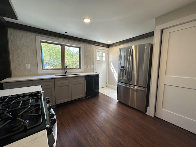 8 Main St, Bennington, NH 03442 - kitchen with stainless steel appliances, a sink, light countertops, dark wood-style floors, and tasteful backsplash