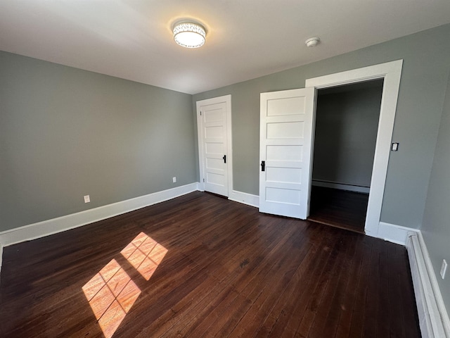 8 Main St, Bennington, NH 03442 - unfurnished bedroom with dark wood finished floors, a baseboard radiator, and baseboards
