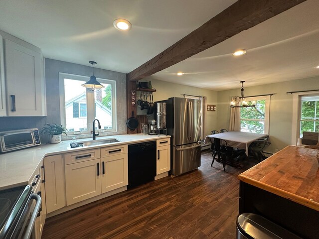 8 Main St, Bennington, NH 03442 - kitchen featuring black dishwasher, a sink, freestanding refrigerator, dark wood-style floors, and a chandelier