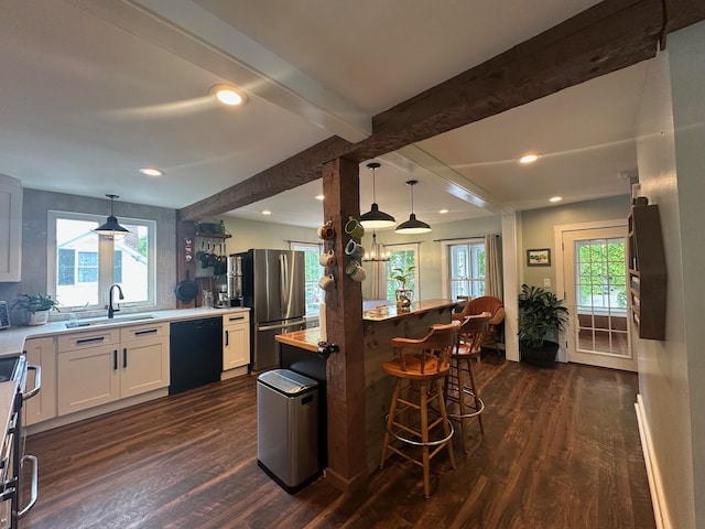 8 Main St, Bennington, NH 03442 - kitchen with stainless steel appliances, dark wood-type flooring, white cabinetry, healthy amount of natural light, and beamed ceiling
