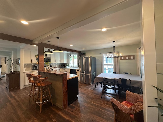 8 Main St, Bennington, NH 03442 - kitchen featuring stainless steel appliances, white cabinetry, dark wood finished floors, a sink, and beamed ceiling