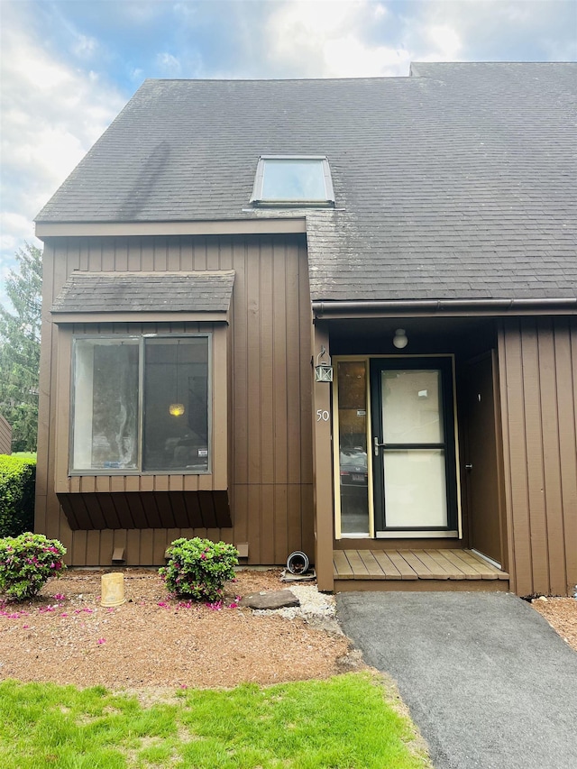 50 Spring Cove Rd, Nashua, NH 03062 - view of front facade with a shingled roof and board and batten siding