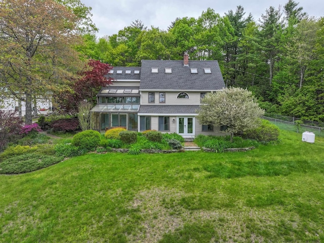 278 N Rd, Deerfield, NH 03037 - rear view of house with french doors, a chimney, roof with shingles, and a forest view
