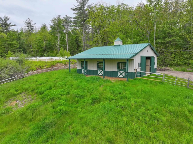 278 N Rd, Deerfield, NH 03037 - view of front of house with metal roof, a wooded view, and an outdoor structure