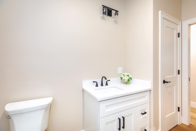 465 Ocean Blvd Unit 201, Hampton, NH 03842 - bathroom featuring toilet, vanity, and wood finished floors