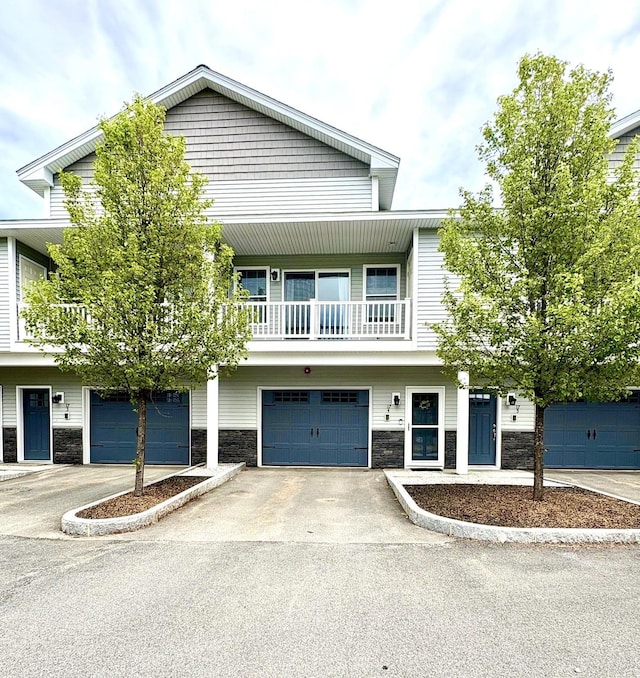 17 Callaway Dr Unit 4, Concord, NH 03301 - townhome / multi-family property featuring stone siding, a balcony, driveway, and a garage