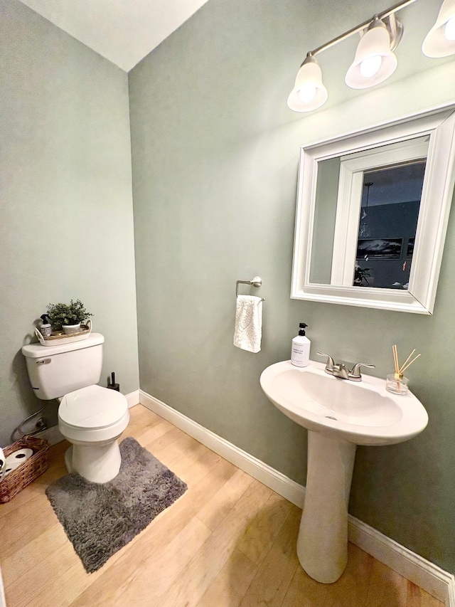 17 Callaway Dr Unit 4, Concord, NH 03301 - bathroom with wood finished floors, toilet, baseboards, and a sink