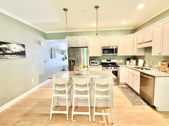 17 Callaway Dr Unit 4, Concord, NH 03301 - kitchen with stainless steel appliances, a sink, crown molding, light wood-type flooring, and white cabinets