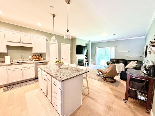 17 Callaway Dr Unit 4, Concord, NH 03301 - kitchen with a sink, crown molding, stainless steel dishwasher, open floor plan, and light wood finished floors