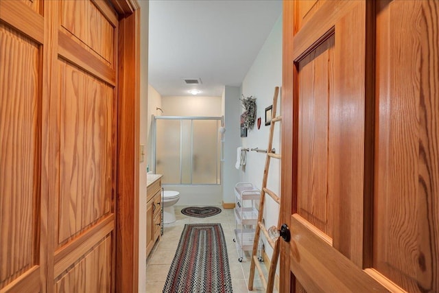 132 Lake Rd, Warren, VT 05674 - bathroom featuring toilet, vanity, combined bath / shower with glass door, and tile patterned floors