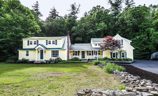 202 Wheeler Rd, Hollis, NH 03049 - view of front of house featuring covered porch, a chimney, and a front yard