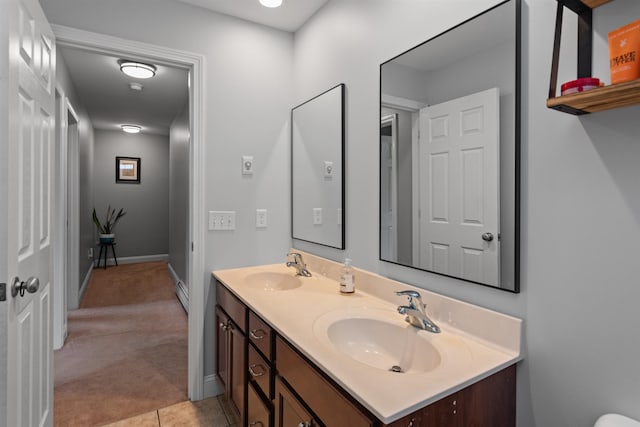 6 Pheasant Run Rd, Fairfax, VT 05454 - bathroom featuring double vanity, baseboards, a baseboard radiator, and tile patterned flooring