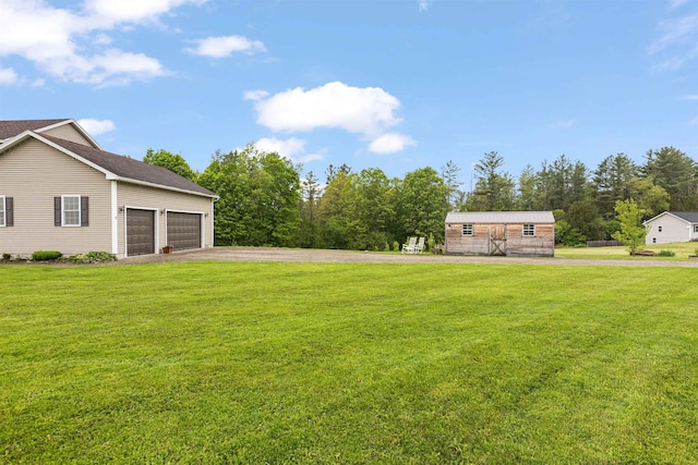 6 Pheasant Run Rd, Fairfax, VT 05454 - view of grassy yard featuring driveway and a garage