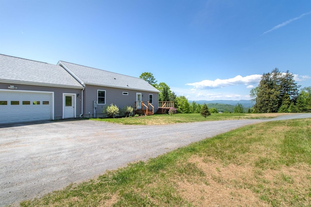 76 Back Of The Moon Rd, Kirby, VT 05832 - view of home's exterior with dirt driveway, an attached garage, and roof with shingles