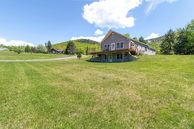 76 Back Of The Moon Rd, Kirby, VT 05832 - rear view of property with a deck with mountain view and a lawn