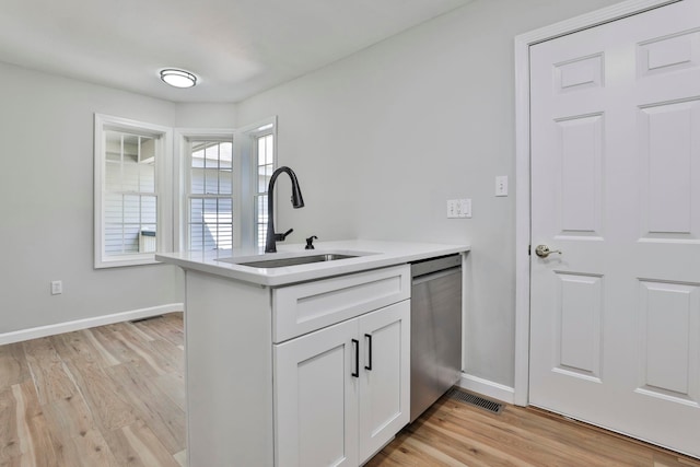1465 Hooksett Rd Unit 403, Hooksett, NH 03106 - kitchen with stainless steel dishwasher, a sink, light wood-style floors, and baseboards