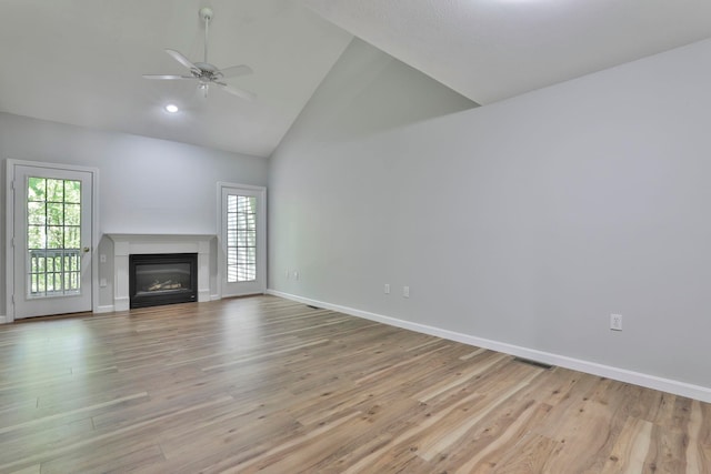 1465 Hooksett Rd Unit 403, Hooksett, NH 03106 - unfurnished living room with ceiling fan, high vaulted ceiling, a glass covered fireplace, and wood finished floors