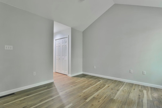 1465 Hooksett Rd Unit 403, Hooksett, NH 03106 - spare room featuring vaulted ceiling, baseboards, and wood finished floors