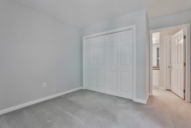 1465 Hooksett Rd Unit 403, Hooksett, NH 03106 - unfurnished bedroom featuring carpet flooring, baseboards, and a closet