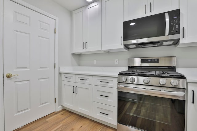 1465 Hooksett Rd Unit 403, Hooksett, NH 03106 - kitchen with stainless steel appliances, white cabinets, and light wood-type flooring