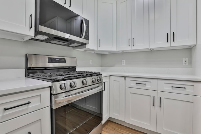 1465 Hooksett Rd Unit 403, Hooksett, NH 03106 - kitchen with appliances with stainless steel finishes, white cabinets, and light wood-style flooring