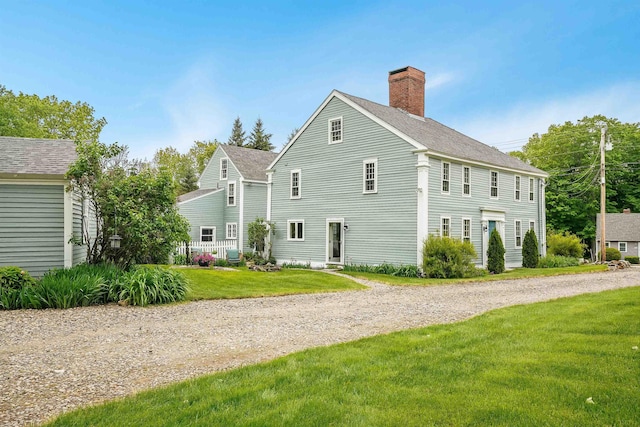 245-247 Danville Rd, Fremont, NH 03044 - view of property exterior with a chimney, a yard, central AC, and a shingled roof