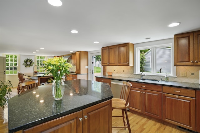 245-247 Danville Rd, Fremont, NH 03044 - kitchen featuring light wood-style flooring, a breakfast bar area, a center island, backsplash, and recessed lighting