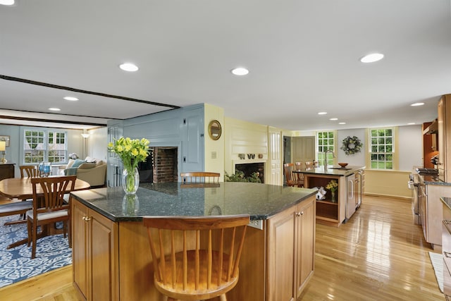 245-247 Danville Rd, Fremont, NH 03044 - kitchen featuring a kitchen island, a fireplace, light wood finished floors, open floor plan, and recessed lighting