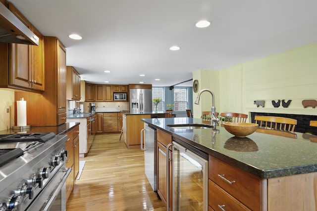 245-247 Danville Rd, Fremont, NH 03044 - kitchen with wine cooler, appliances with stainless steel finishes, an island with sink, under cabinet range hood, and a sink