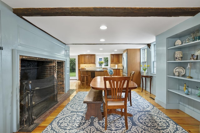 245-247 Danville Rd, Fremont, NH 03044 - dining area with light wood-style flooring, recessed lighting, a fireplace with flush hearth, and beam ceiling