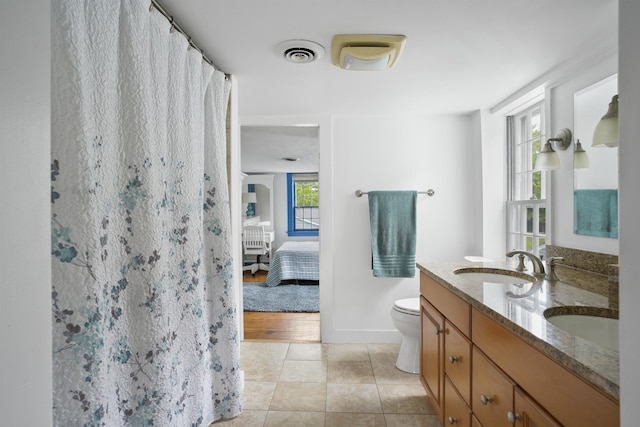 245-247 Danville Rd, Fremont, NH 03044 - ensuite bathroom featuring double vanity, toilet, tile patterned flooring, baseboards, and a shower with curtain