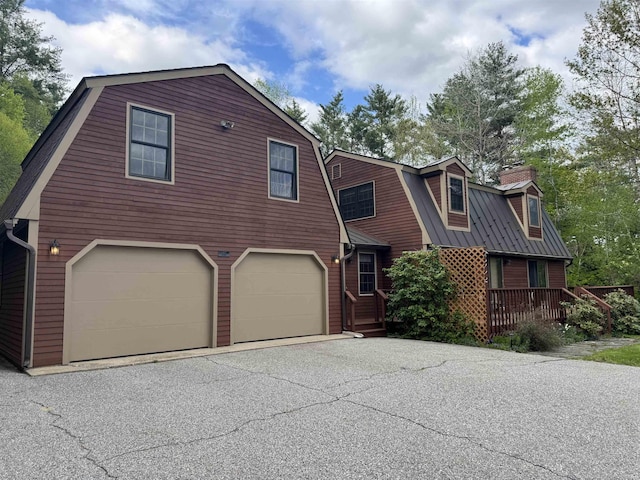52 Jericho Rd, Grantham, NH 03753 - dutch colonial featuring a gambrel roof, a garage, asphalt driveway, a chimney, and metal roof
